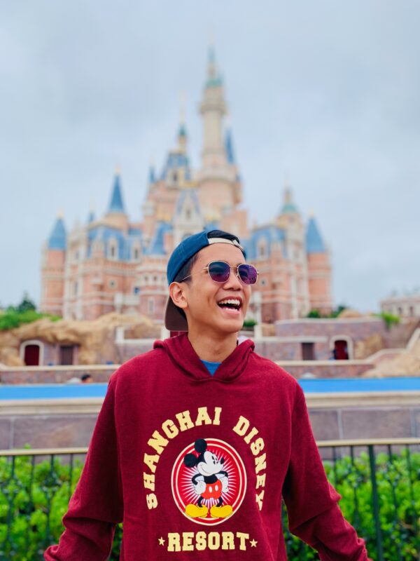 Smiling in front of the Enchanted Storybook Castle in Shanghai Disneyland